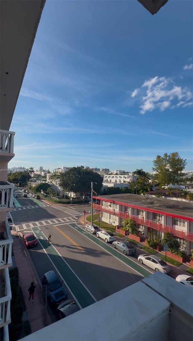 view of road featuring a view of city, curbs, and sidewalks