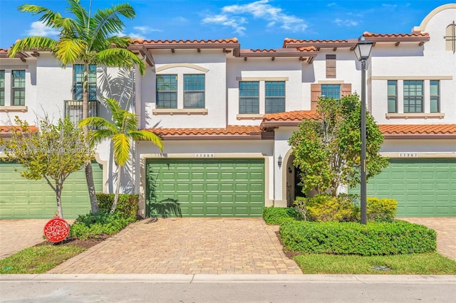 mediterranean / spanish-style house with a garage