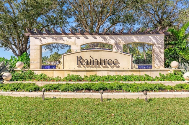 community sign featuring a lawn