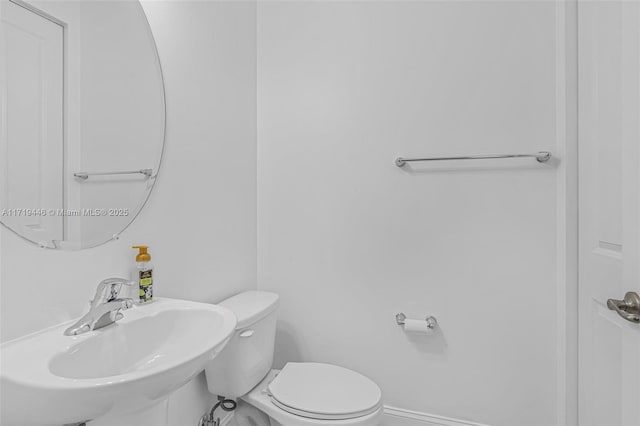 bathroom with sink and toilet