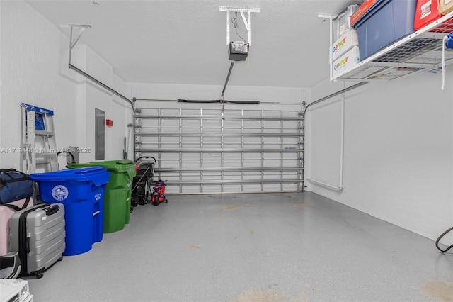 garage with a garage door opener and electric panel