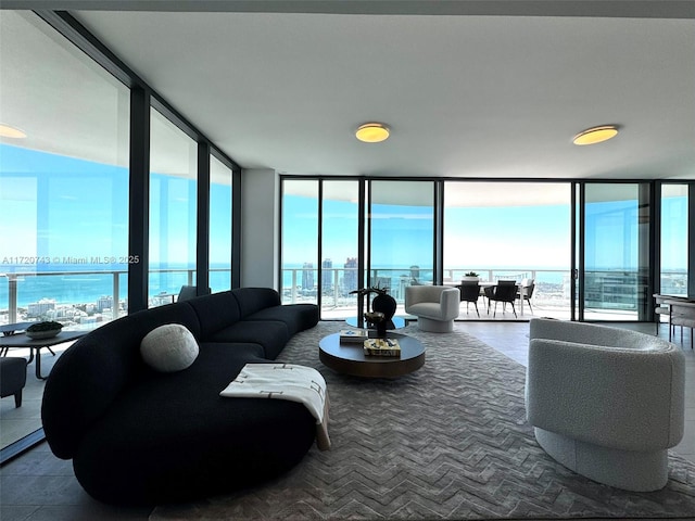 living room featuring expansive windows and a water view