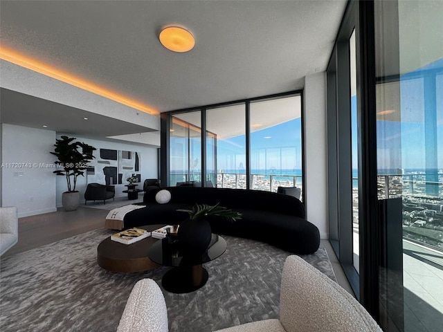 living area with expansive windows and a textured ceiling