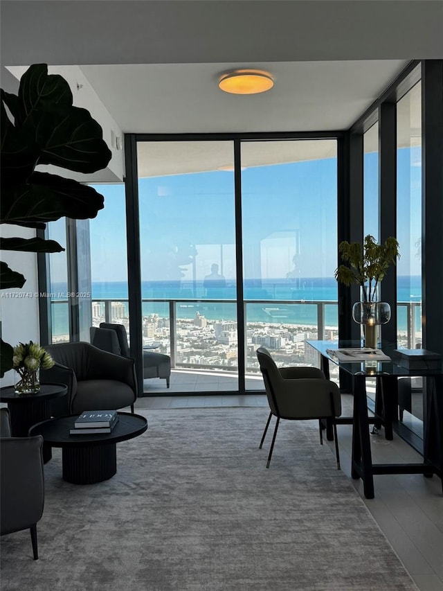 living area with a water view and floor to ceiling windows