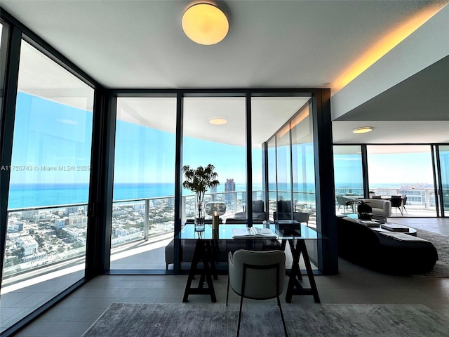 dining room featuring a water view and floor to ceiling windows