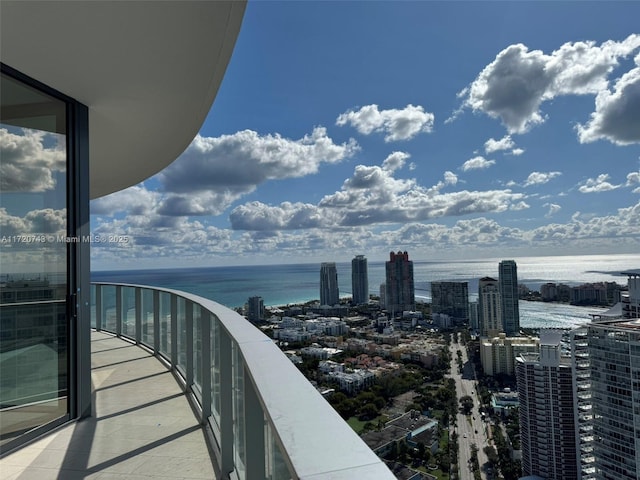 balcony with a water view and a city view