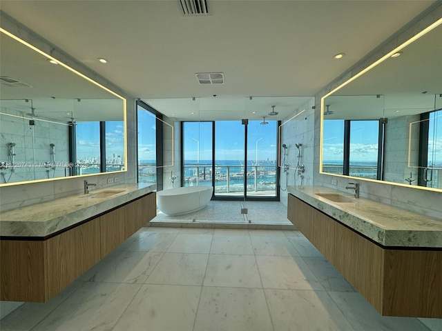 bathroom featuring visible vents, a sink, and a shower stall