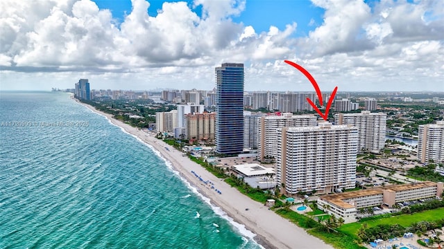 aerial view with a water view and a beach view