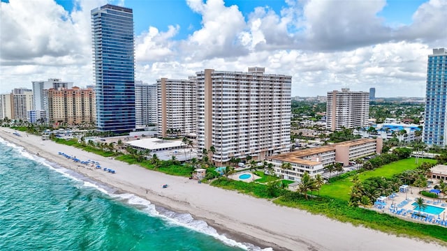 drone / aerial view with a beach view and a water view