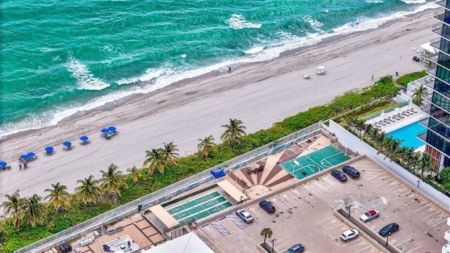 bird's eye view with a water view and a view of the beach