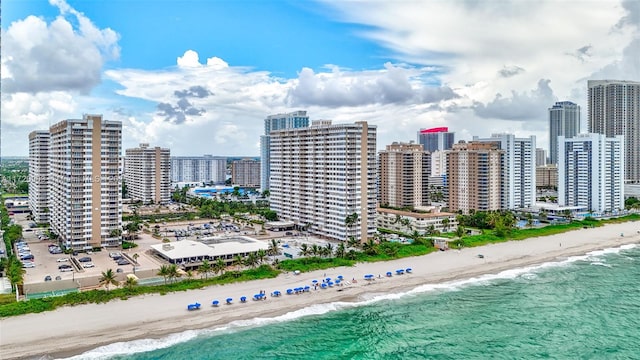 bird's eye view with a water view and a beach view