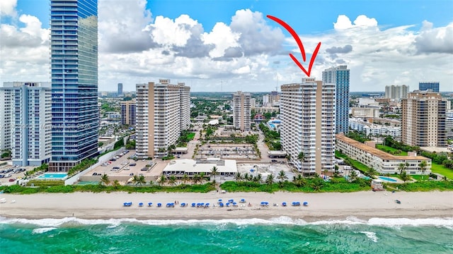 aerial view with a water view and a beach view