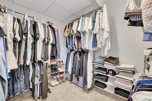 walk in closet featuring a paneled ceiling and light tile patterned floors