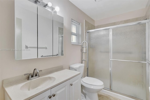 bathroom featuring toilet, vanity, and an enclosed shower