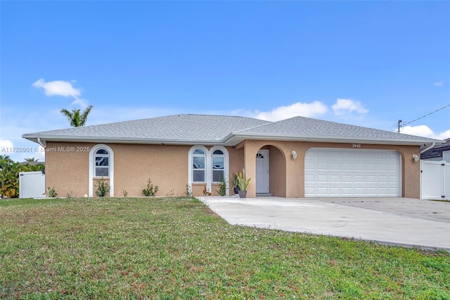 single story home with a garage and a front lawn