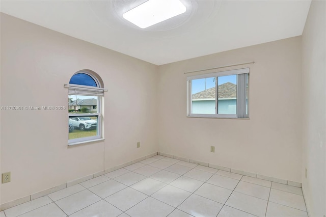 spare room featuring light tile patterned floors