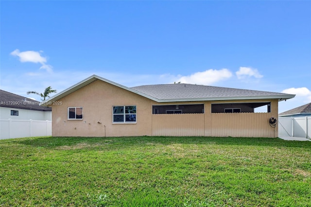 rear view of property with a yard