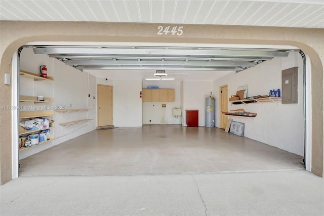 garage featuring a garage door opener, electric panel, and electric water heater