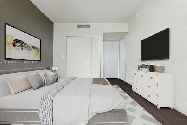 bedroom featuring dark hardwood / wood-style flooring and a closet