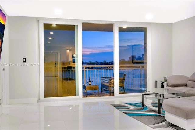 living room featuring tile patterned floors and a water view