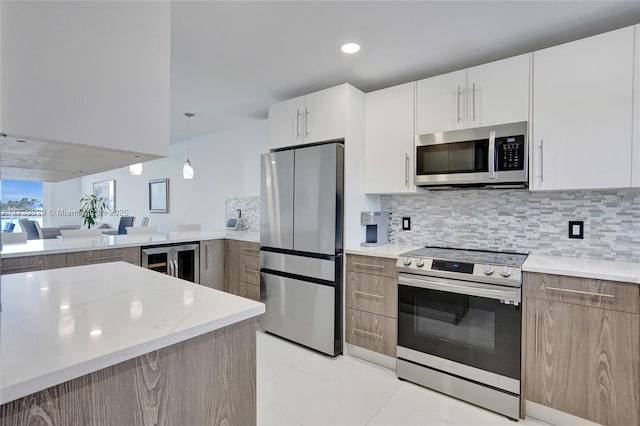 kitchen with backsplash, white cabinets, hanging light fixtures, wine cooler, and stainless steel appliances