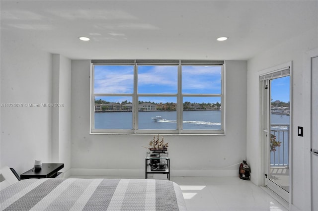 unfurnished bedroom featuring a water view