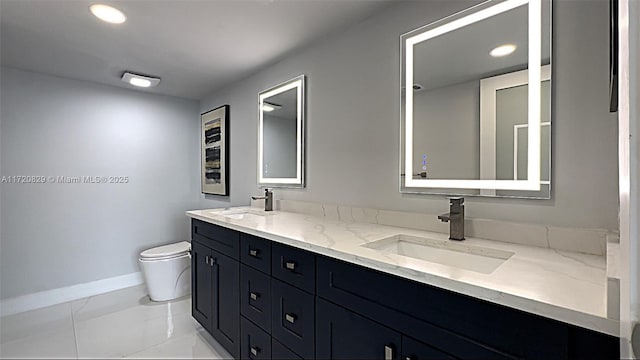 bathroom with tile patterned floors, vanity, and toilet