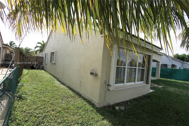 view of side of home featuring a lawn