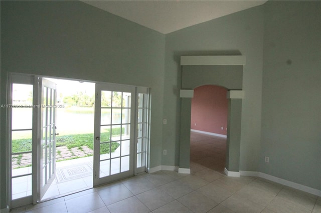 tiled spare room with french doors