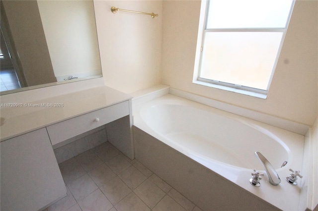 bathroom with vanity, tile patterned floors, and a bathtub