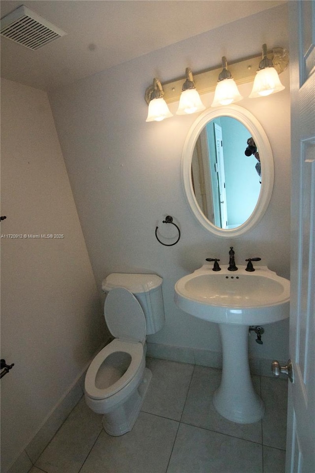 bathroom featuring tile patterned flooring and toilet