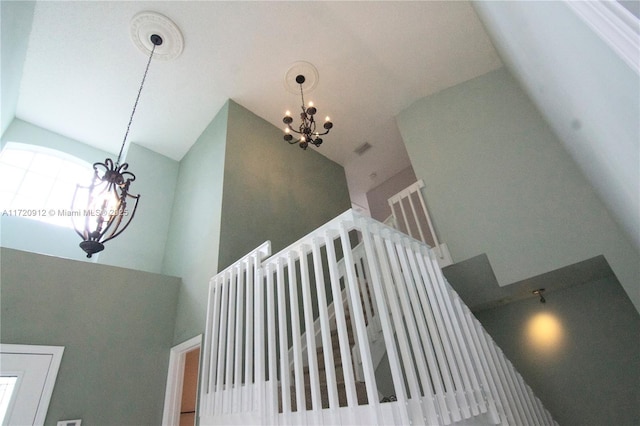 stairway with an inviting chandelier