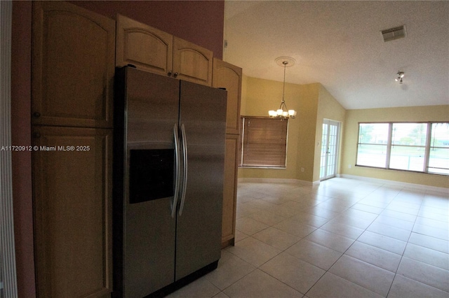 kitchen with vaulted ceiling, decorative light fixtures, a notable chandelier, light tile patterned floors, and stainless steel refrigerator with ice dispenser