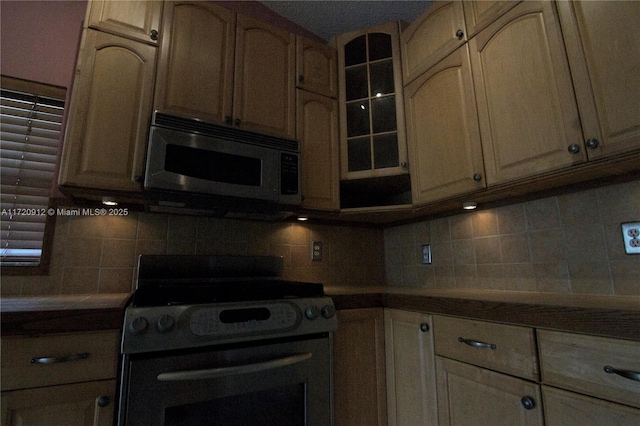 kitchen featuring stainless steel appliances and tasteful backsplash