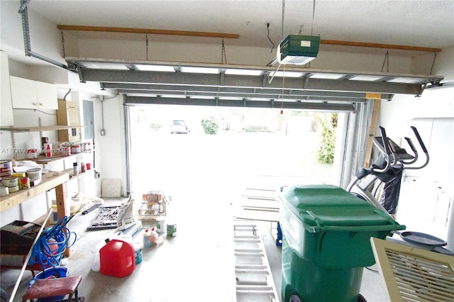 garage with electric panel and a garage door opener