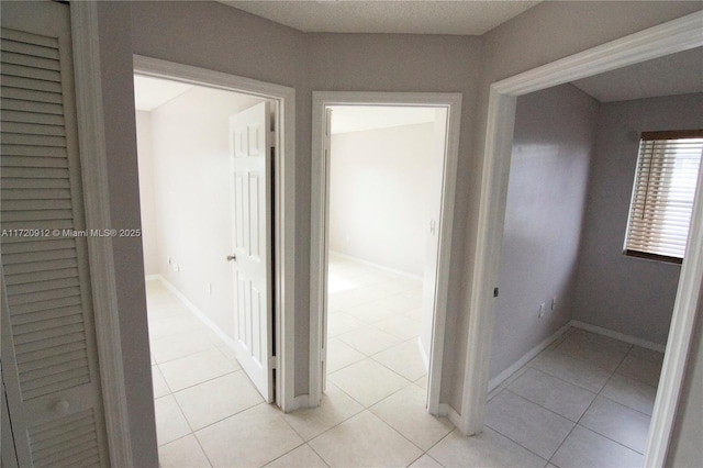 hall with light tile patterned floors