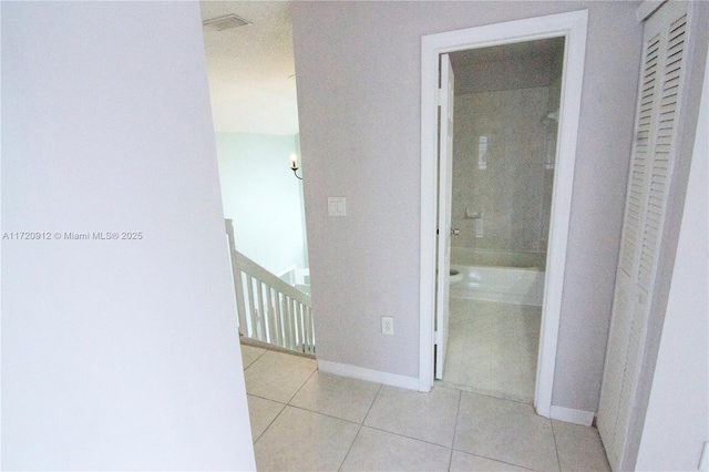 hallway featuring light tile patterned floors