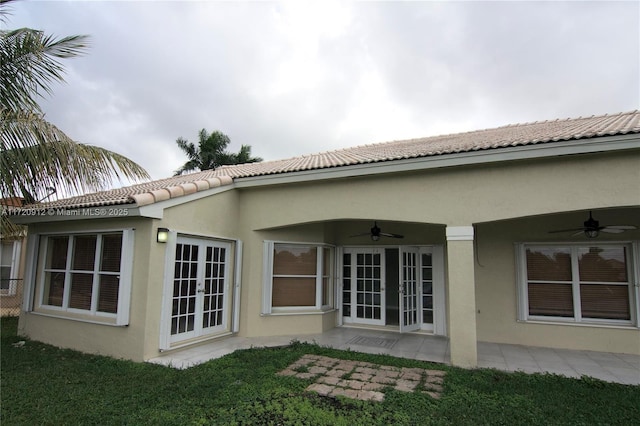 back of house with ceiling fan, french doors, and a yard