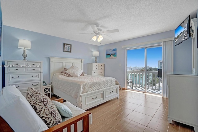 bedroom with ceiling fan, a textured ceiling, and access to outside