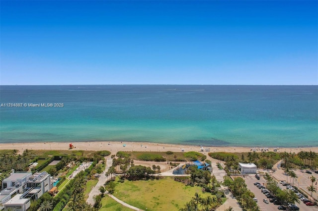 drone / aerial view with a water view and a beach view