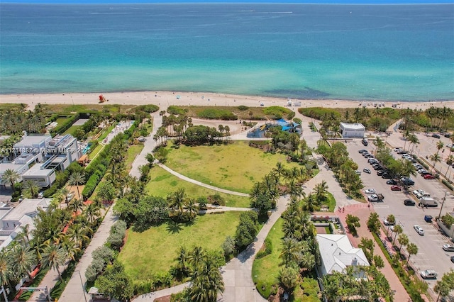 bird's eye view featuring a water view and a beach view