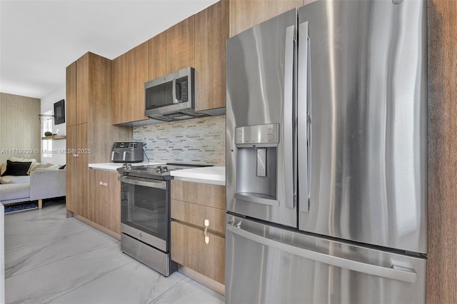 kitchen with appliances with stainless steel finishes and tasteful backsplash