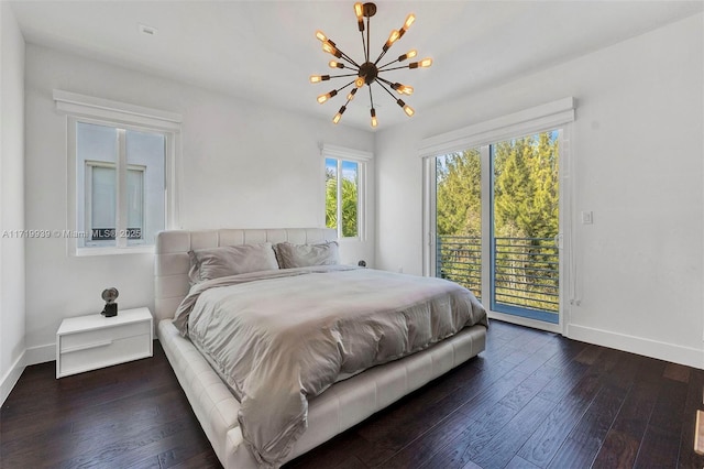 bedroom with access to exterior, dark hardwood / wood-style flooring, and a chandelier