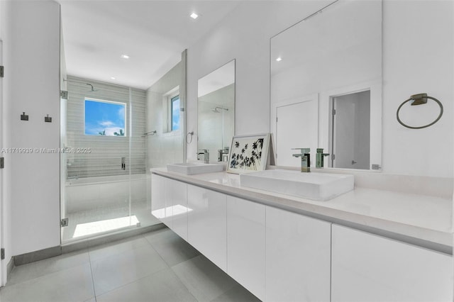 bathroom with tile patterned flooring, vanity, and an enclosed shower