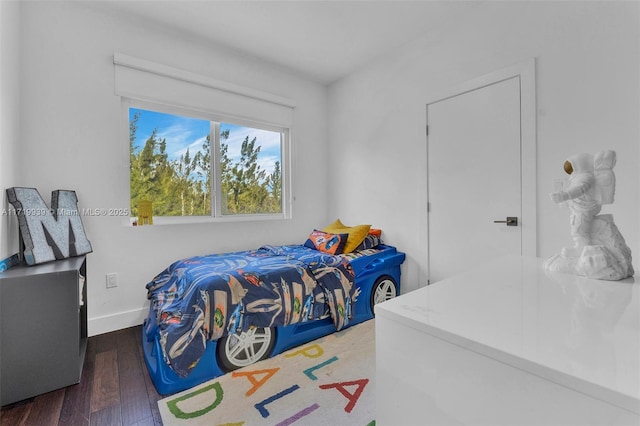 bedroom with dark hardwood / wood-style floors