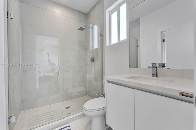 bathroom with walk in shower, tile patterned floors, vanity, and toilet