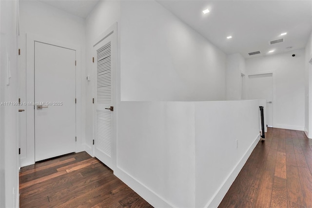 corridor with dark hardwood / wood-style flooring