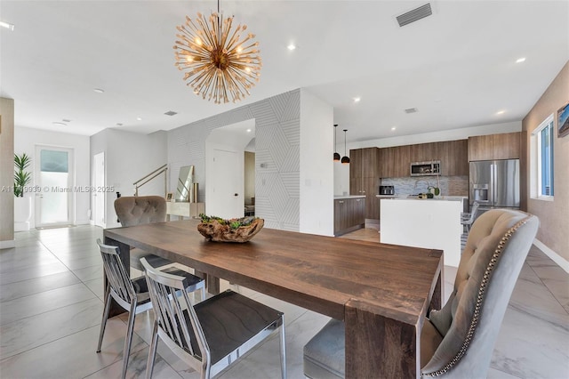 dining area featuring an inviting chandelier and a healthy amount of sunlight