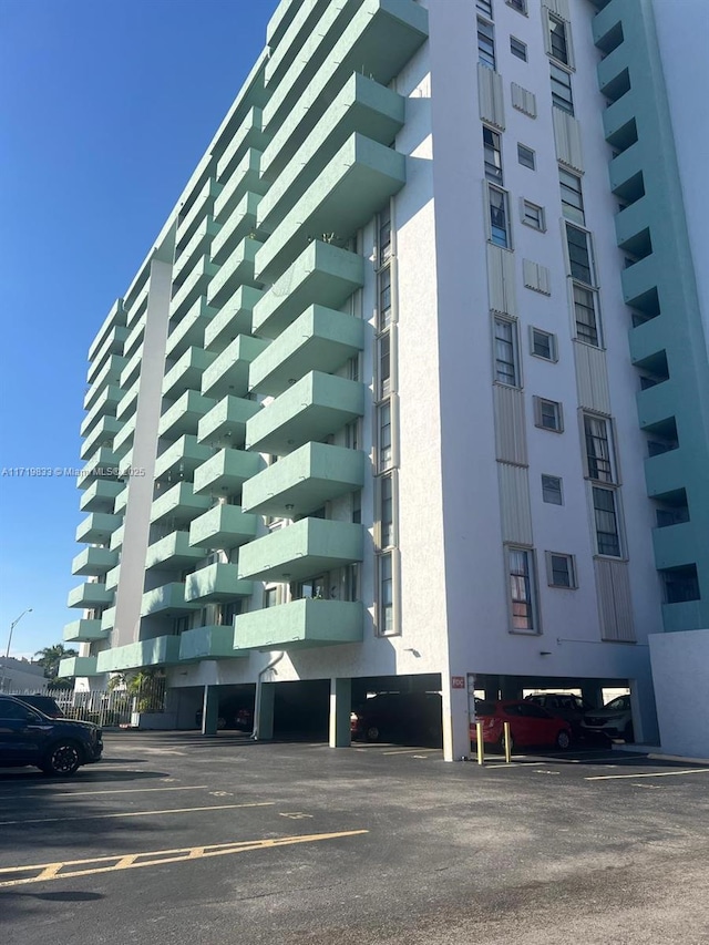 view of building exterior featuring uncovered parking