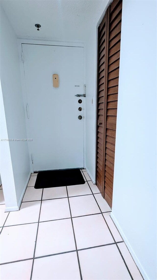 entryway with light tile patterned flooring